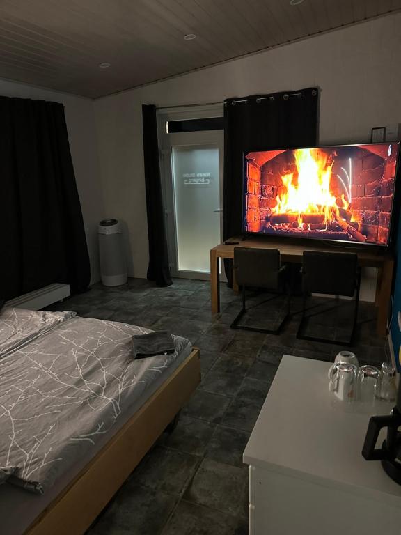 a bedroom with a bed and a fire in a fireplace at Übernachtungsmöglichkeit und Monteurzimmer in Hamdorf