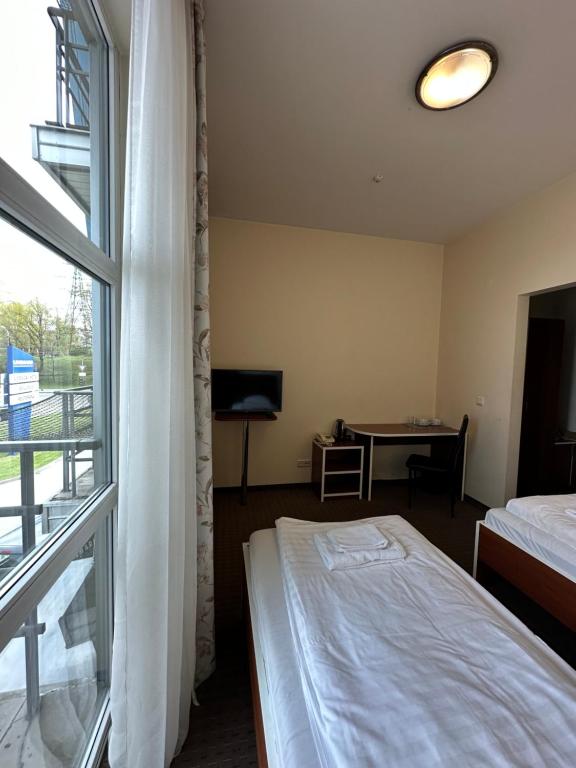 Postel nebo postele na pokoji v ubytování Riga Unimars Hotel