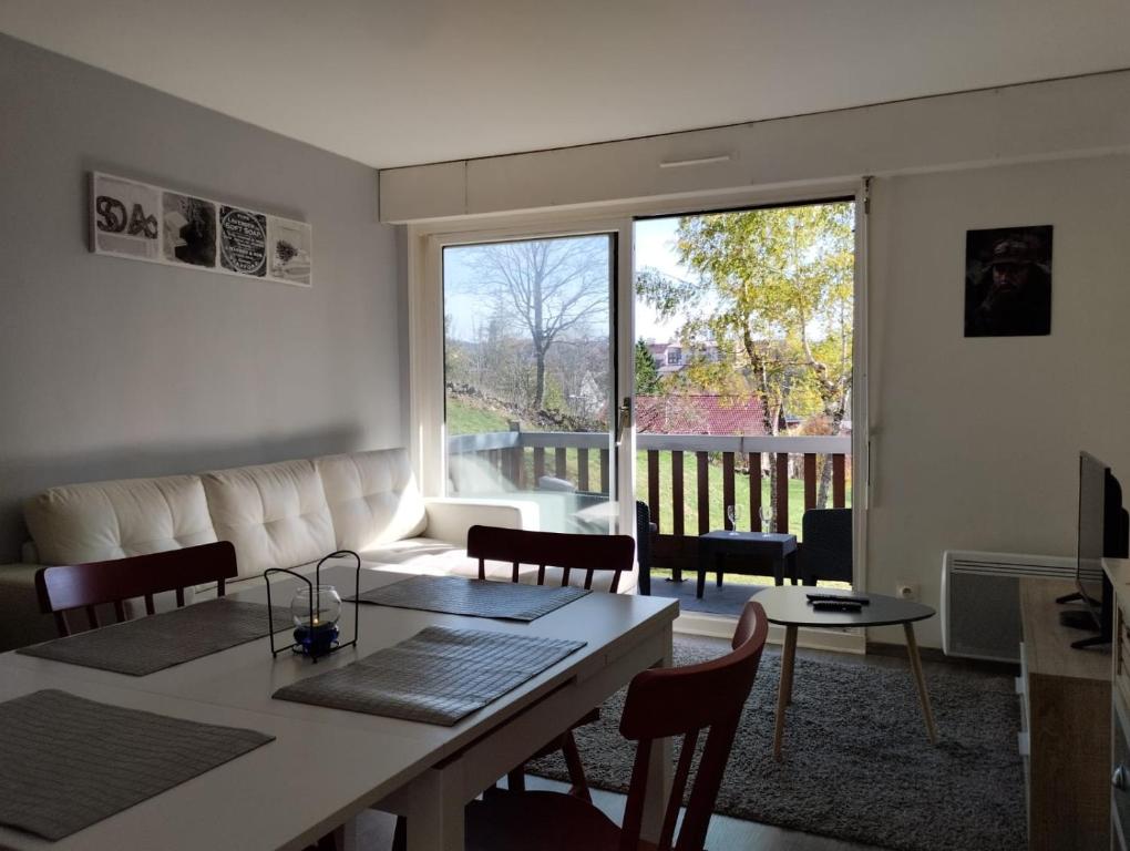 een woonkamer met een bank en een tafel bij Appartement les Rousses Bien situé in Les Rousses
