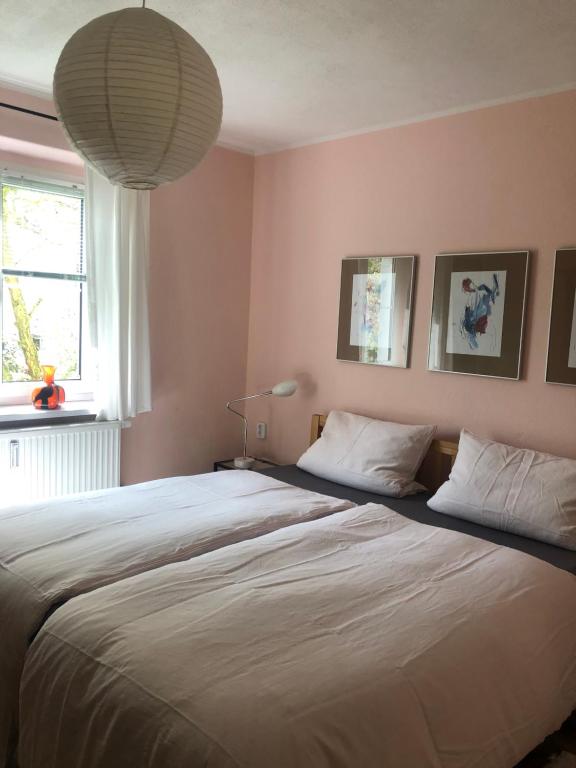 a bedroom with a large bed with two pillows at Wohlfühloase Dresden Nickern in Dresden