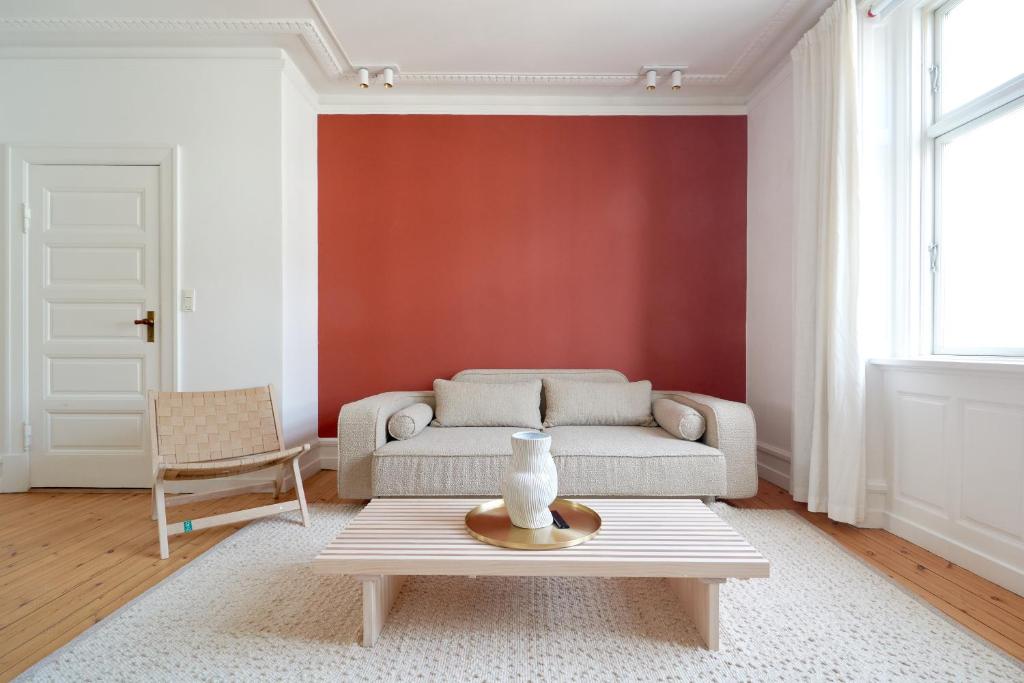 a living room with a couch and a table at Famous Lakes Apt - City Central in Copenhagen