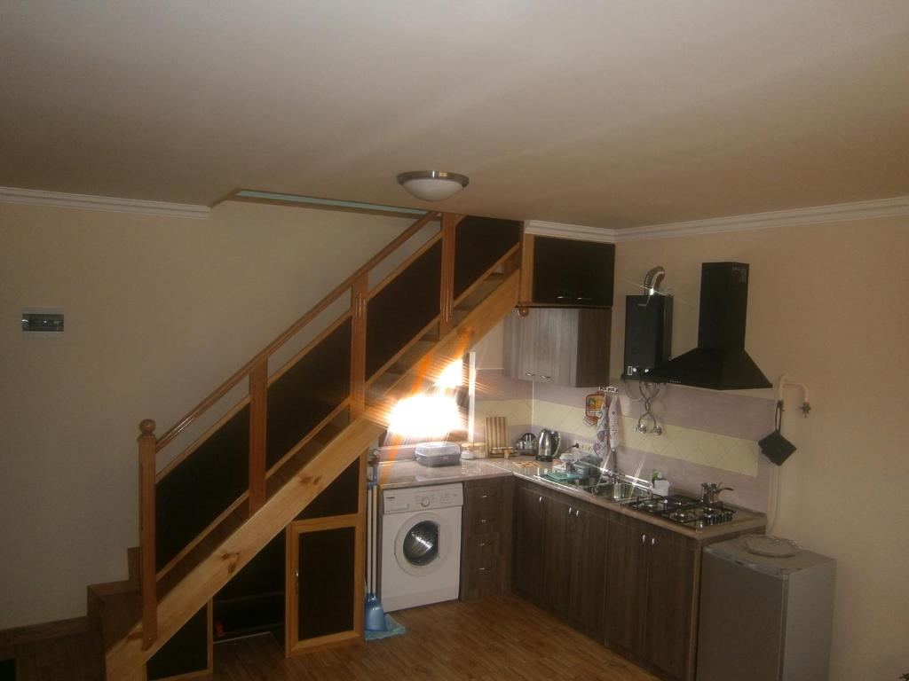 a kitchen with a staircase with a washing machine at Aygestan Comfort Holiday Home in Yerevan
