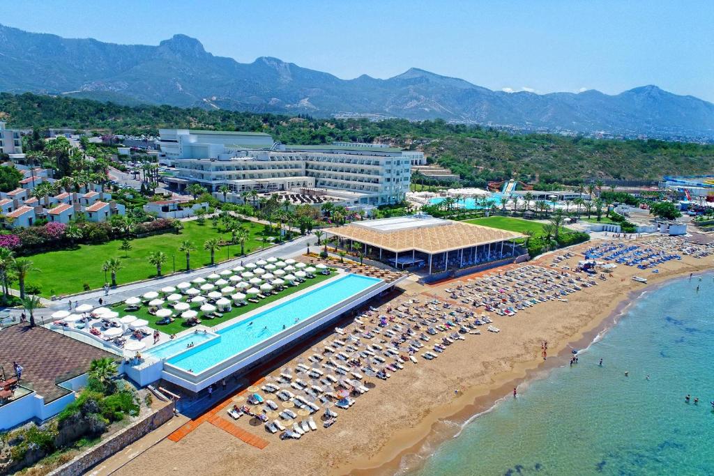 an aerial view of a resort with a pool and beach at Acapulco Resort Hotel in Kyrenia