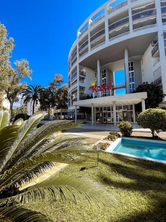 a large building with a swimming pool in front of it at Royal in Salou