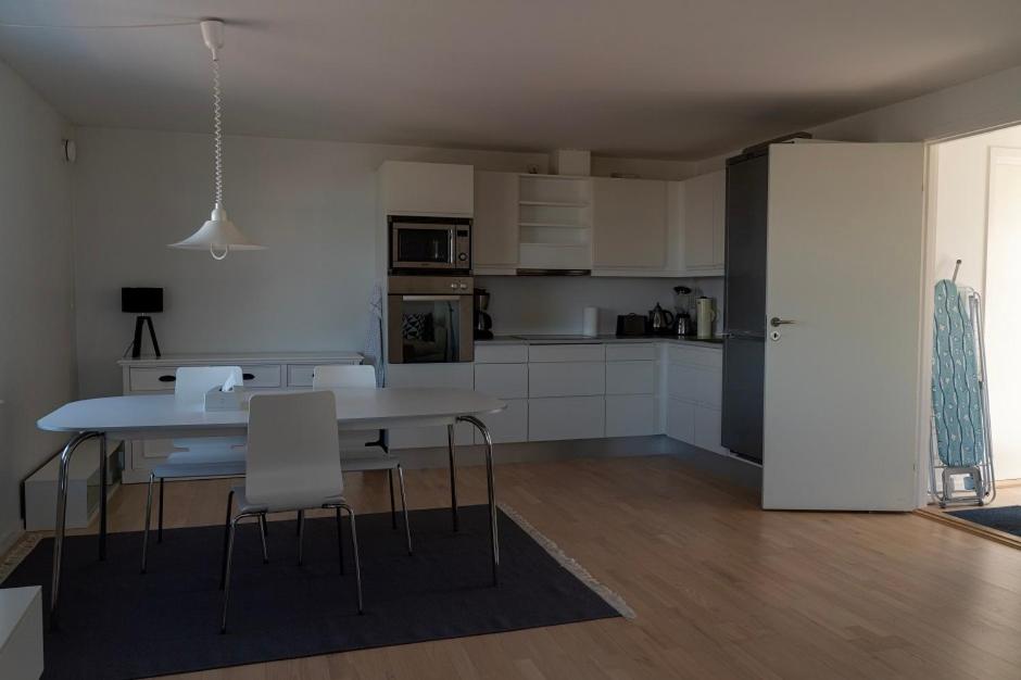 a kitchen and dining room with a table and chairs at Hotel Nuka in Ilulissat