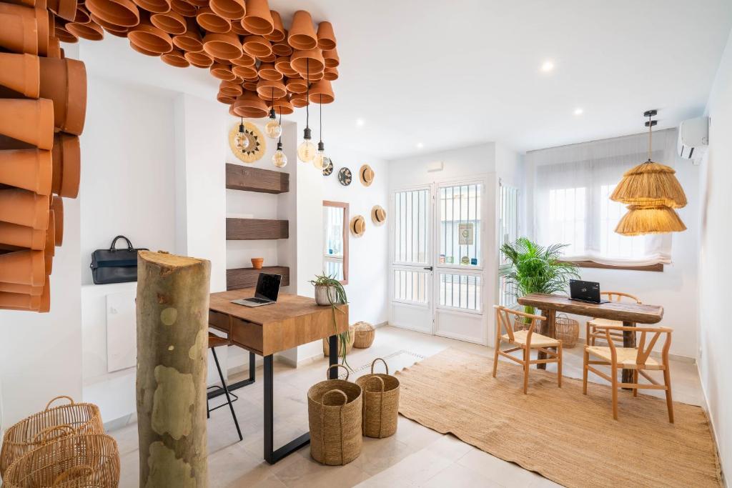 a living room with a table and a dining room at BF Rooms Carboneras in Carboneras