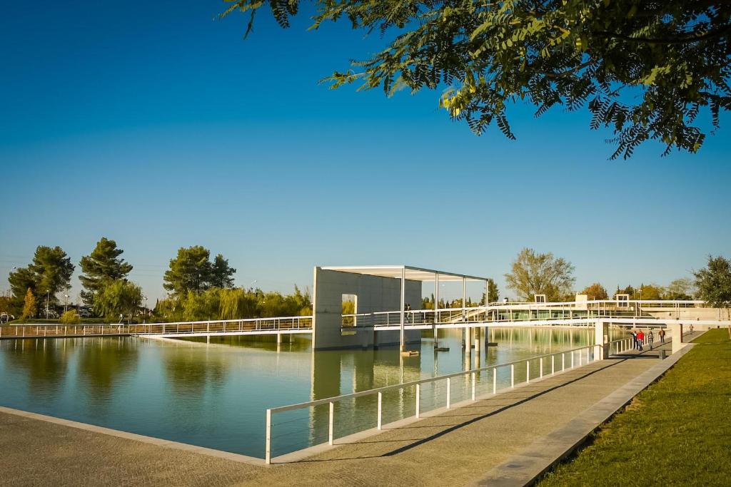 a bridge over a body of water with a building at Casa Modesta II in Beja