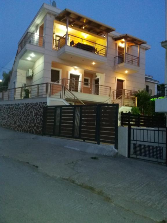 a house with a gate in front of it at Casa Loutsiano in Syvota