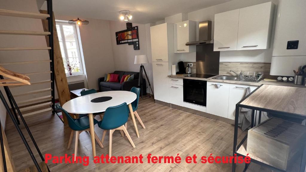 uma cozinha com mesa e cadeiras num quarto em Appartement 6 - hyper-centre Agen avec Garage em Agen