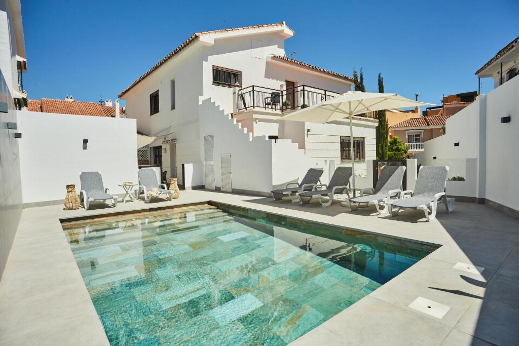 a swimming pool in front of a house at Villa in Fuengirola Center NEW SALT WATER POOL in Fuengirola