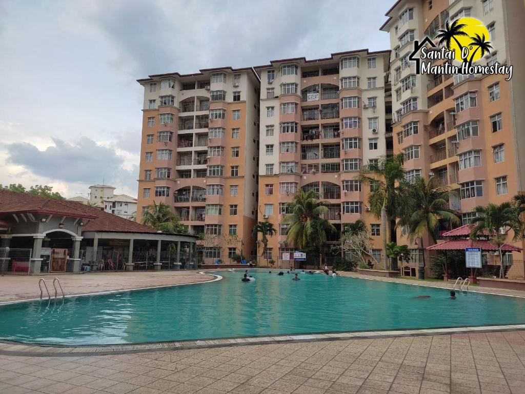 a large swimming pool in front of a building at Santai D' Mantin Homestay in Lengging