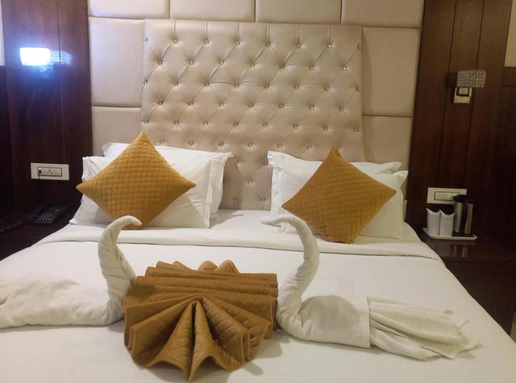 a hotel room with a bed with two towels on it at HOTEL BLUE ORCHID - A 3 STAR HEAVEN IN Tricity in Zirakpur