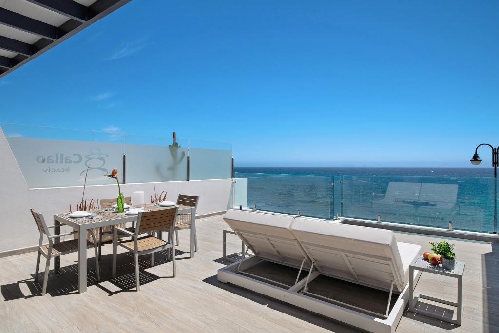 a balcony with a table and chairs and a view at Callao Beach 7 in Arrieta