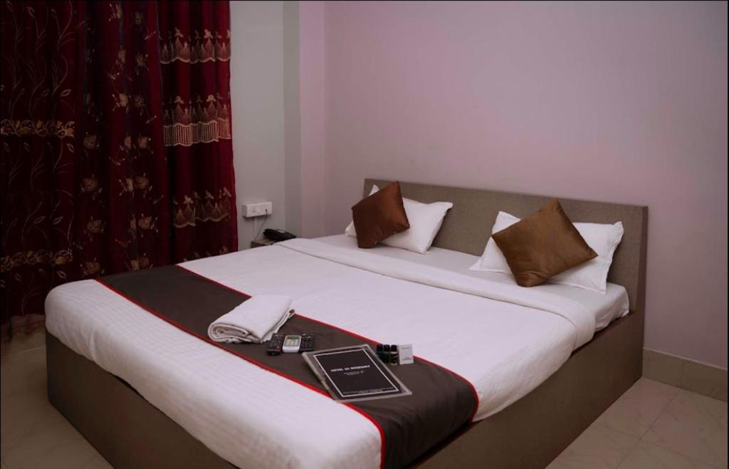 Ένα ή περισσότερα κρεβάτια σε δωμάτιο στο GS RESIDENCY