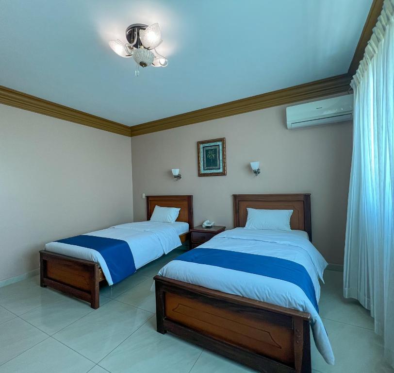 Postel nebo postele na pokoji v ubytování Apart Hotel Hamilton