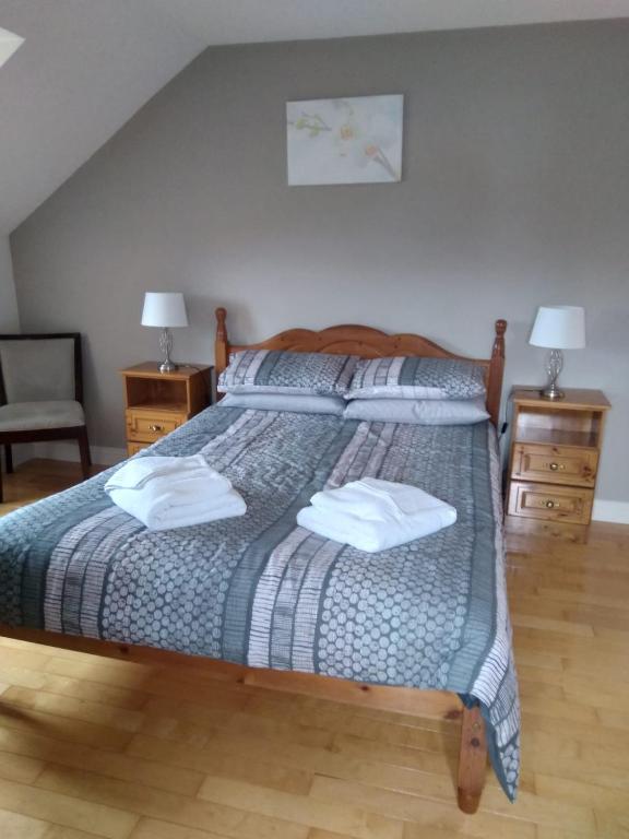 a bedroom with a bed with two pillows on it at Abbeywest House 