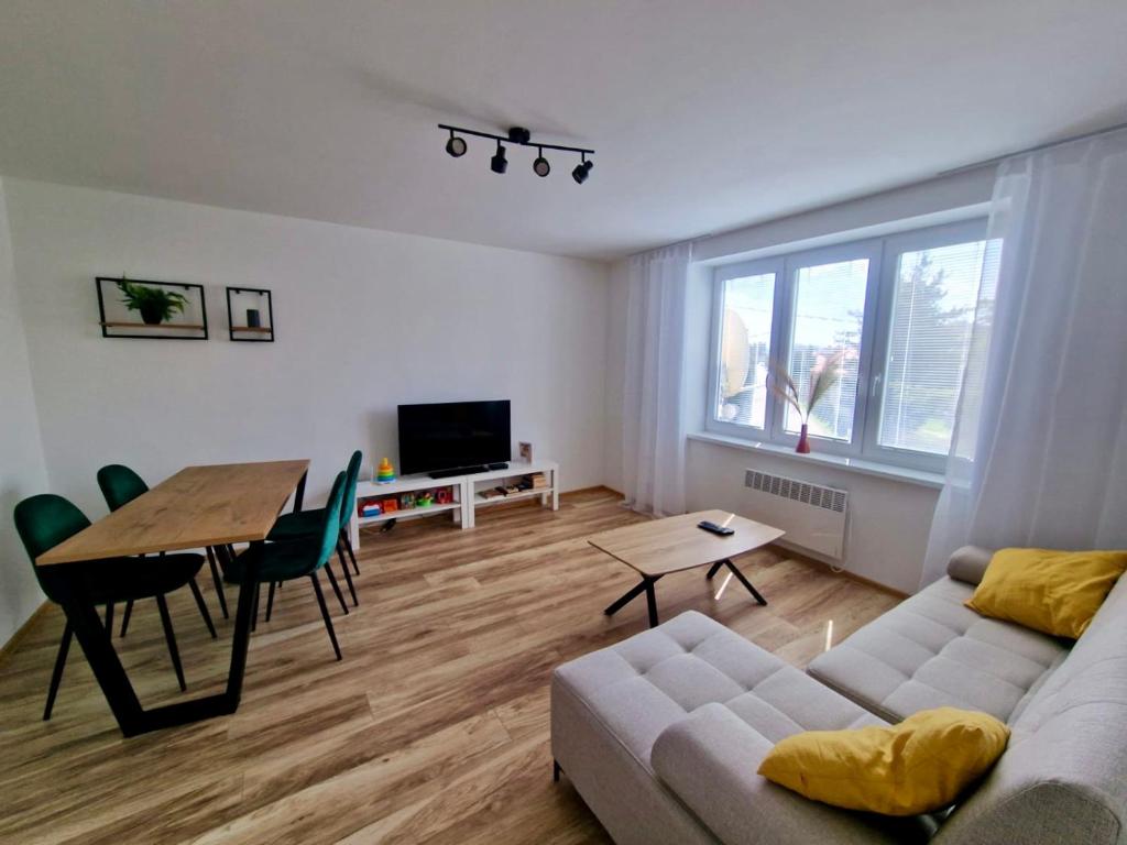 a living room with a couch and a table at Lovely Apartment Vadaš in Štúrovo