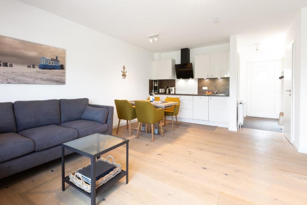 a living room with a couch and a table at Wohnung Peper in Juist