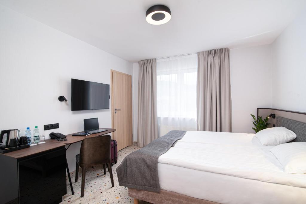 Postel nebo postele na pokoji v ubytování Antares Hotel