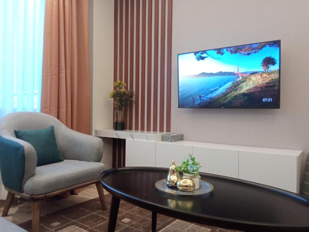 a living room with a tv on a wall at Elegant and comfy apartment in Westlands, Nairobi in Nairobi