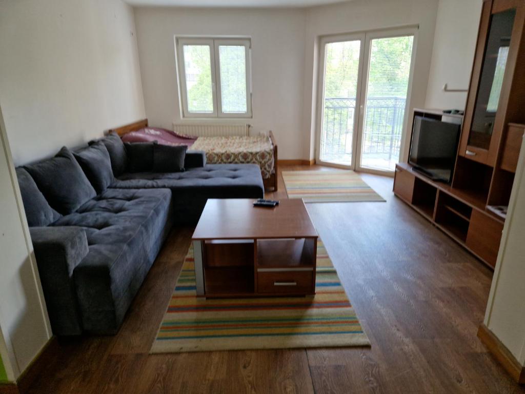 a living room with a couch and a coffee table at Greenspace in Niš