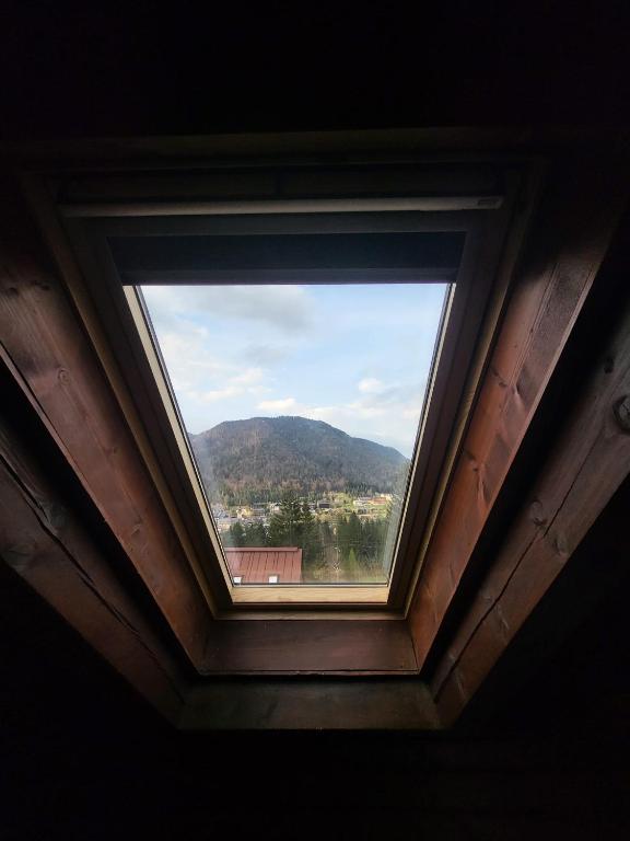 a window in a room with a view of a mountain at La casa lassù in Tarvisio