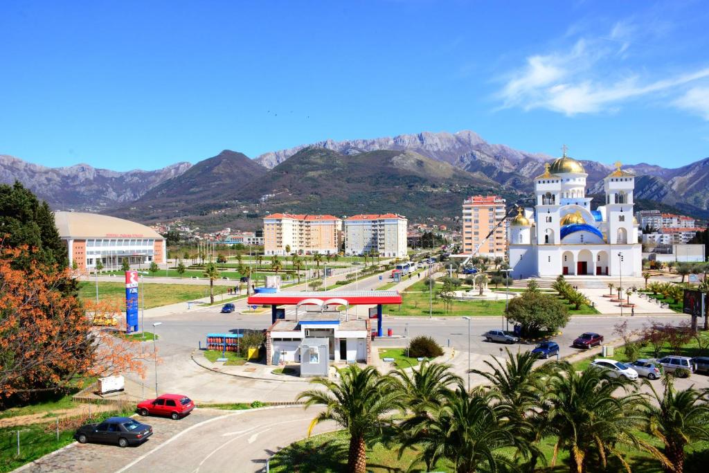 a city with a church and mountains in the background at Hotel Princess in Bar