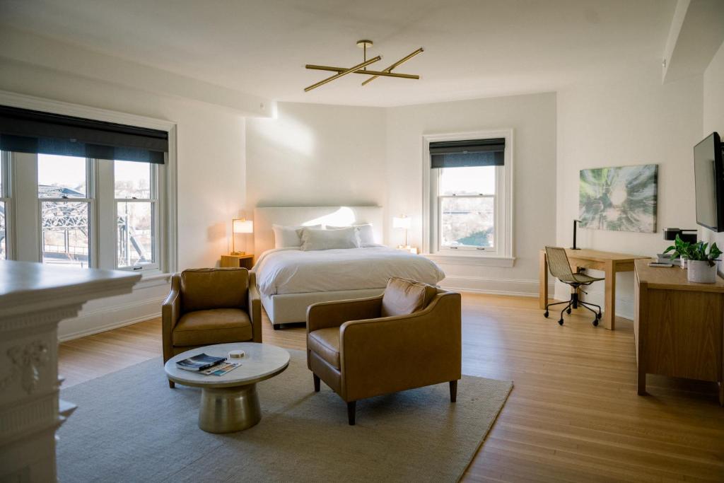 a bedroom with a bed and two chairs and a table at Wilbur Mansion in Bethlehem