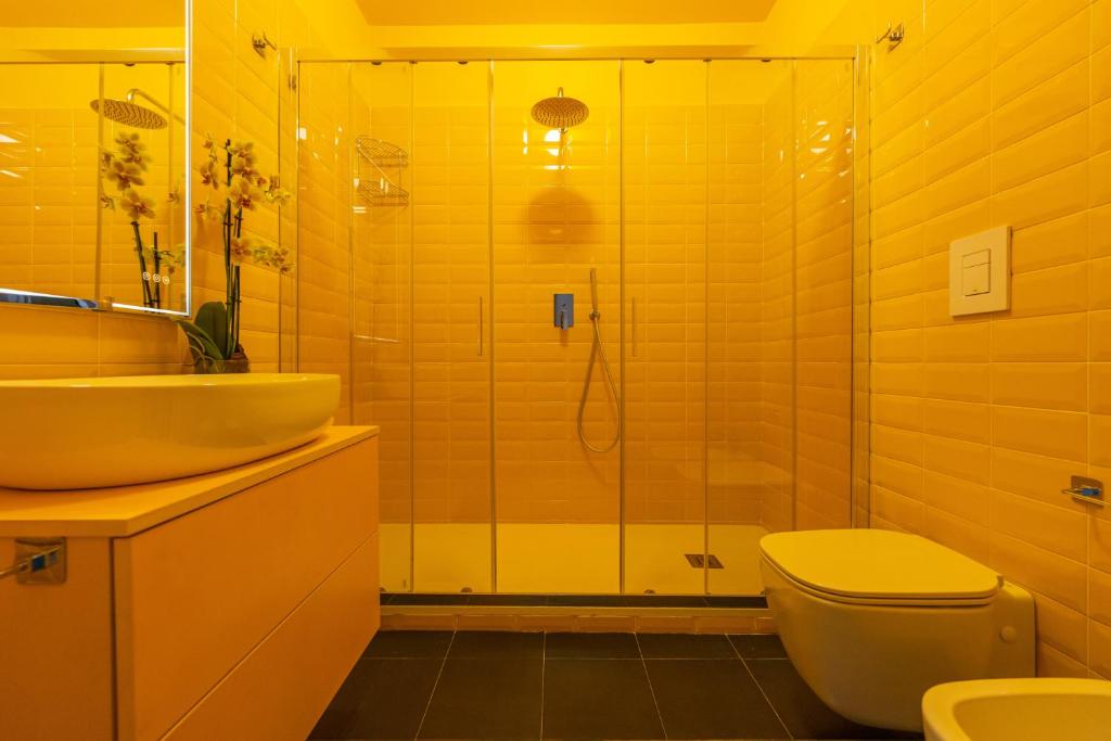 a bathroom with a shower and a sink and a toilet at Teatro Toledo 272 in Naples
