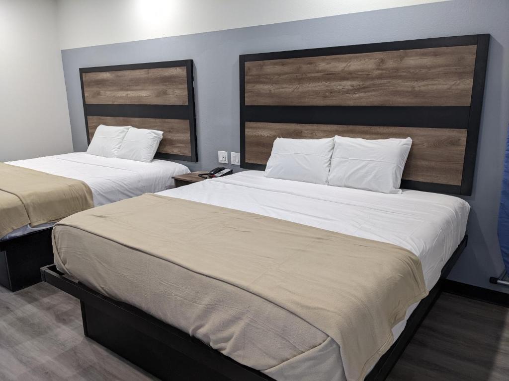 Postel nebo postele na pokoji v ubytování Captain Suites