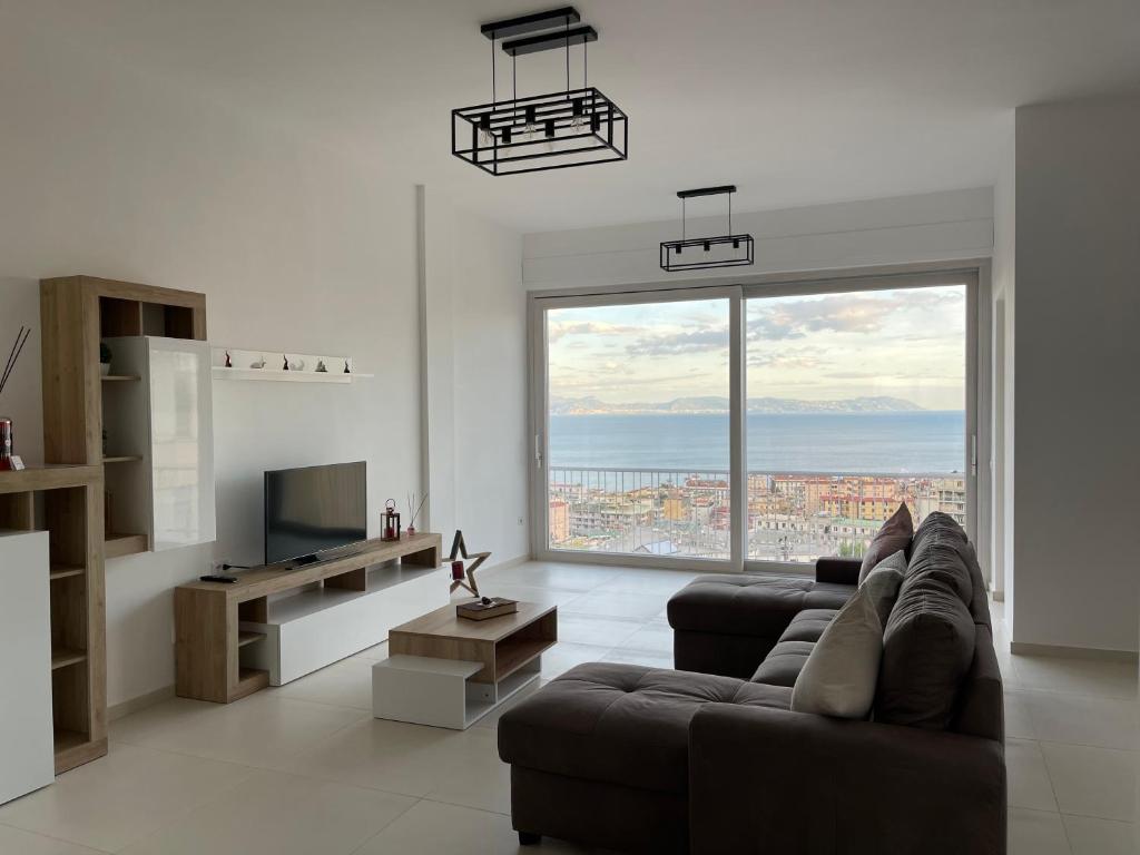 a living room with a couch and a large window at Casa Langellotti plus in Naples