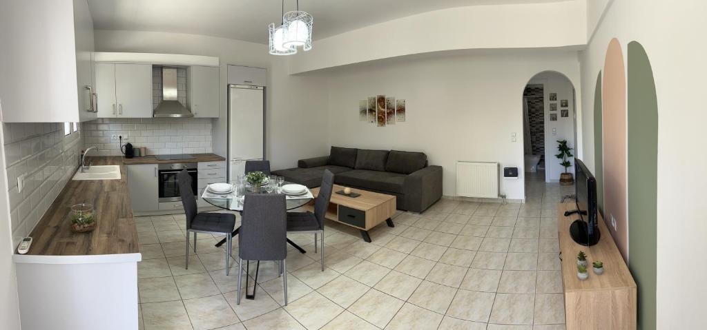 ポルト・ヘリにあるPorfyra Apartment Portoheliのソファとテーブルのあるリビングルームとキッチン