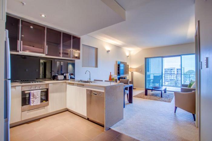 a large kitchen with a view of a living room at Golden Height in eMalahleni