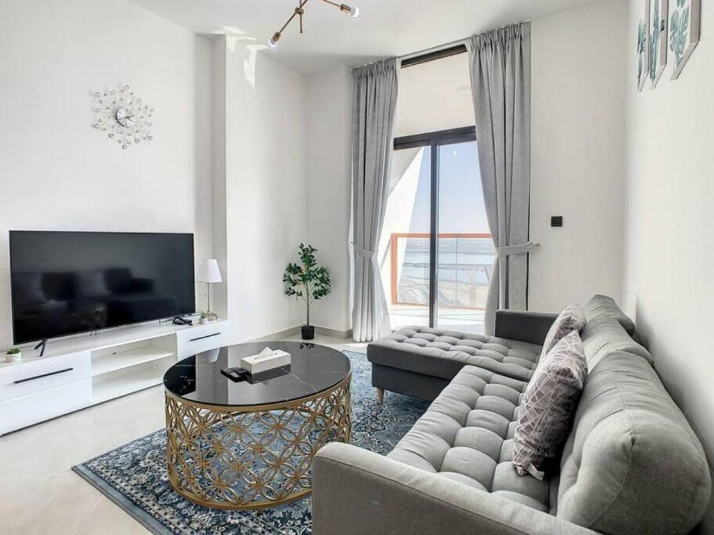 a living room with a couch and a table at Key View - Binghatti Avenue, Al Jaddaf in Dubai