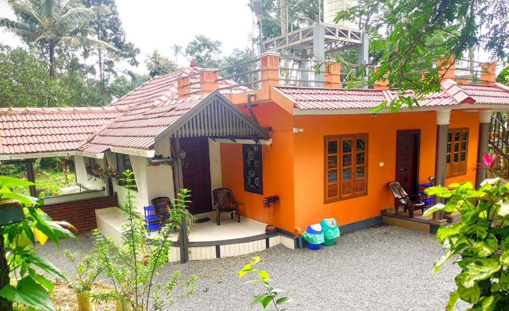 a small house with an orange at Golden Peak Estate Homestay in Wayanad