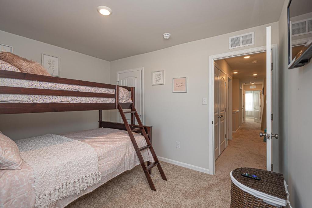 a bedroom with a bunk bed and a hallway at Endless Summer Rental in Millville
