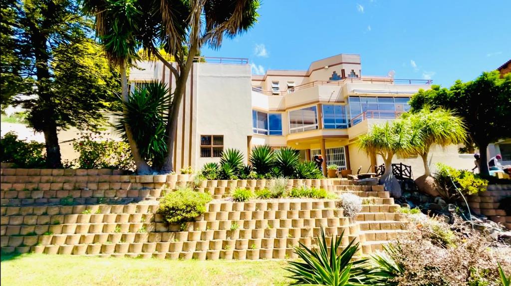 a house with stairs in front of a building at Hotel Vibes Cape Town Plattekloof in Cape Town