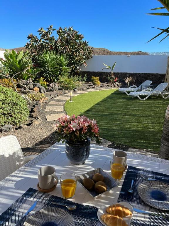 a table with a plate of food on it at Corralejo Tender Suite in Corralejo