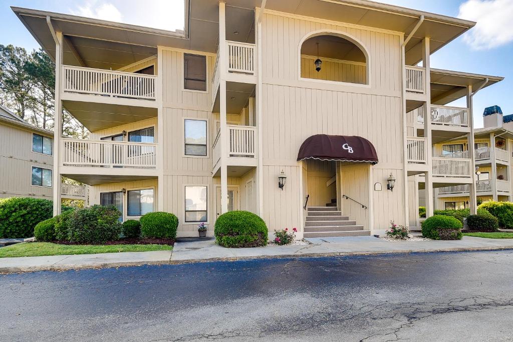 a large apartment building with a driveway in front of it at Little River Condo with Balcony Pool and Hot Tub! in Little River