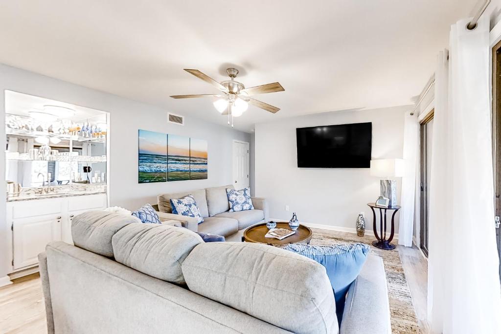 a living room with a couch and a tv at Turtle Cove 4839 in Kiawah Island