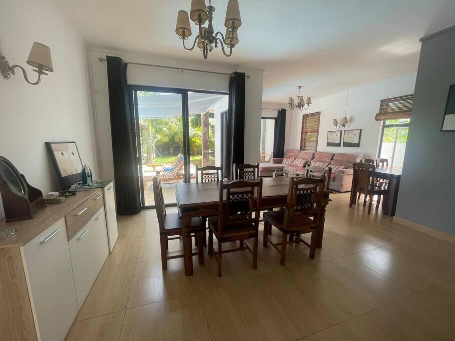 a kitchen and dining room with a table and chairs at Villa Coco in Trou aux Biches
