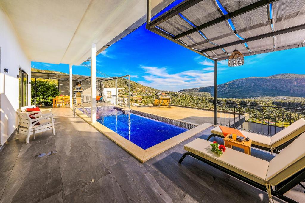 a house with a pool and a view of the mountains at Villa Likya Honeymoon in Kalkan