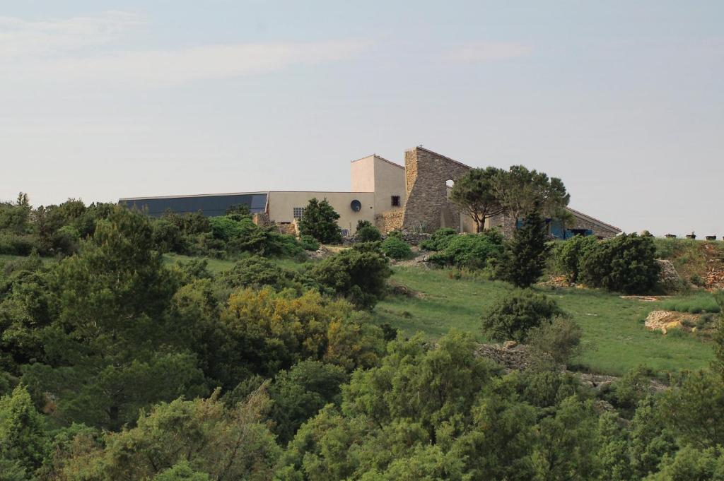 a building on top of a hill with trees at Domaine Castelsec in Roquefort-des-Corbières