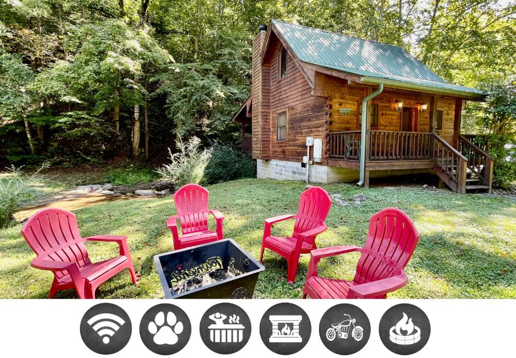 four chairs and a fire pit in front of a log cabin at Creekside cabin in Townsend