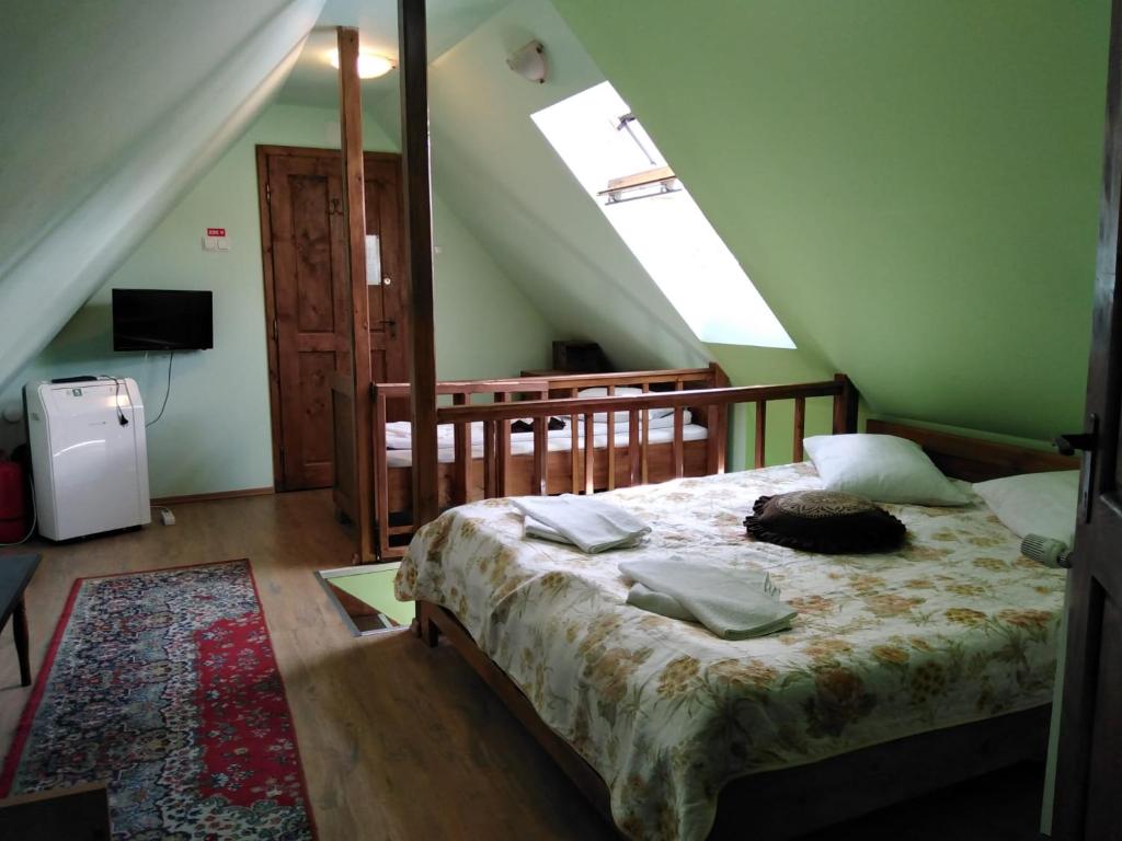 a bedroom with a bed in a attic at Pensiunea Lelila Inn in Sighişoara