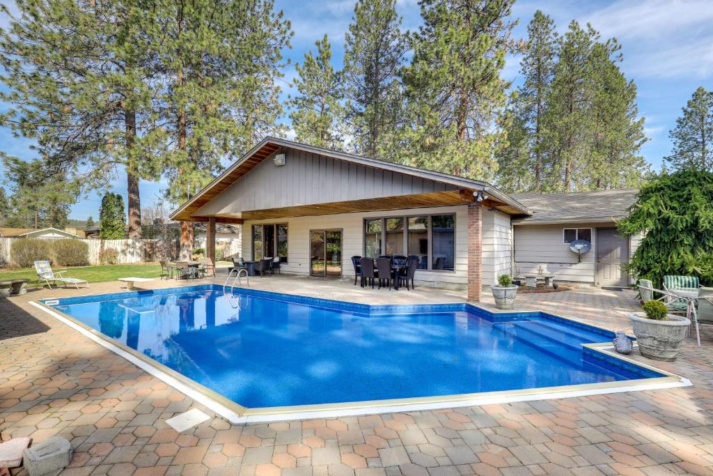 a swimming pool in the backyard of a house at Spokane Valley Vacation Rental with Shared Pool! in Spokane Valley