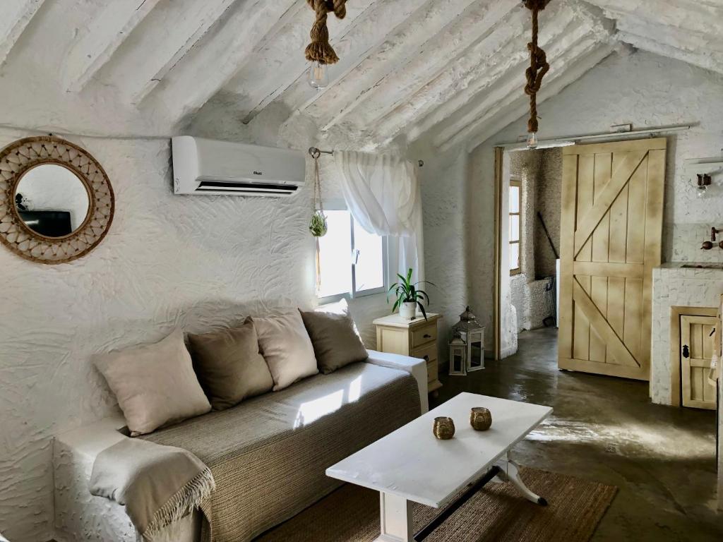 a living room with a couch and a table at Arya's Nest in Mijas