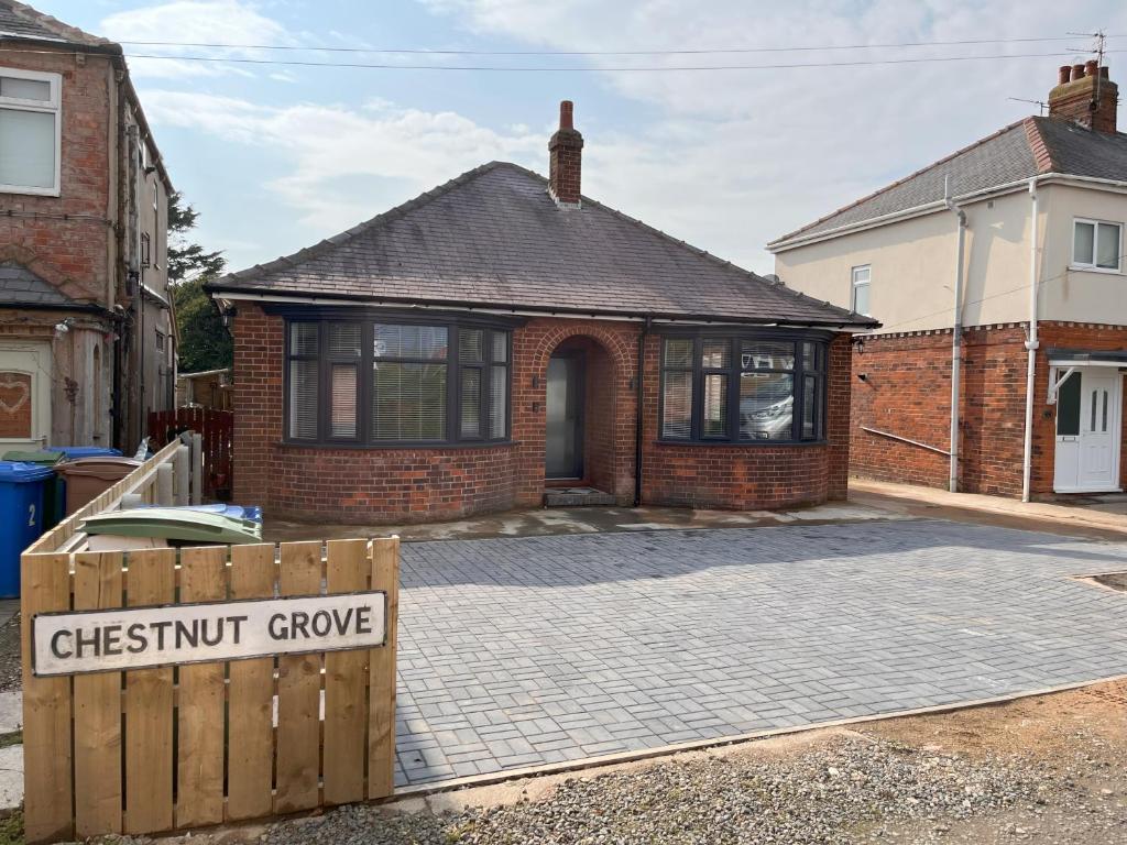 a brick house with a sign that says chestnut grove at No 1 Chestnut Grove in Withernsea