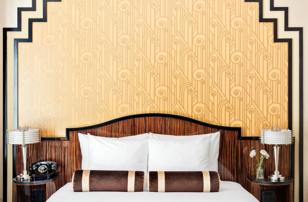 a bedroom with a bed with a wooden head board at Walker Hotel Greenwich Village in New York