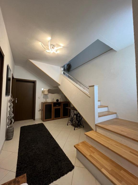 a living room with a staircase in a house at Kuća za odmor Antonini in Kaštela